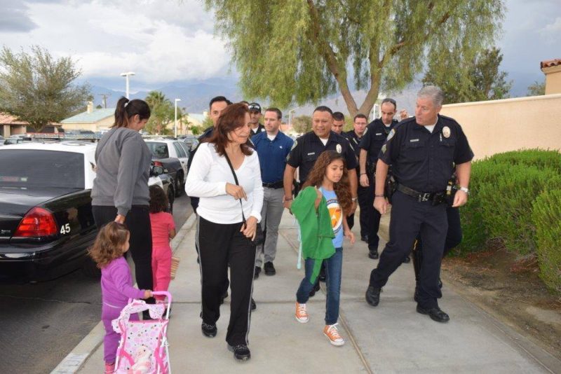 Vanessa Vega, daughter of slain officer Palm Springs Police officer Gil Vega, is escorted to school by members of the PSPD