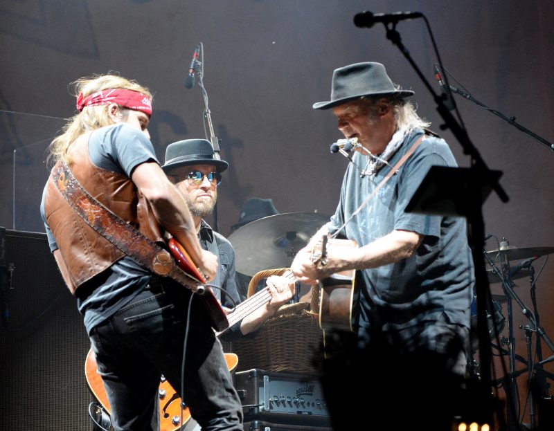 INDIO, CA - OCTOBER 15: Musicians Lukas Nelson, Corey McCormick and Neil Young of Neil Young & Promise of the Real perform onstage during Desert Trip at The Empire Polo Club on October 15, 2016 in Indio, California. (Photo by Kevin Mazur/Getty Images for Desert Trip)