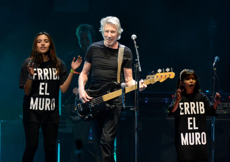 INDIO, CA - OCTOBER 16: Musician Roger Waters (C) performs with a children's choir wearing T-shirts saying 'derriba el muro' (tear down the wall) during Desert Trip at The Empire Polo Club on October 16, 2016 in Indio, California. (Photo by Kevin Mazur/Getty Images for Desert Trip)