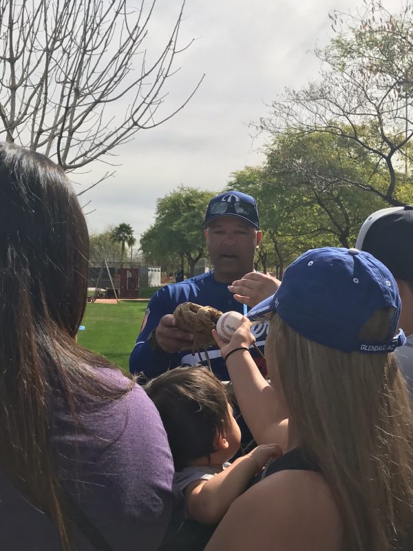 Dodgers manager Dave Roberts signs autographs in Glendale, Arizona