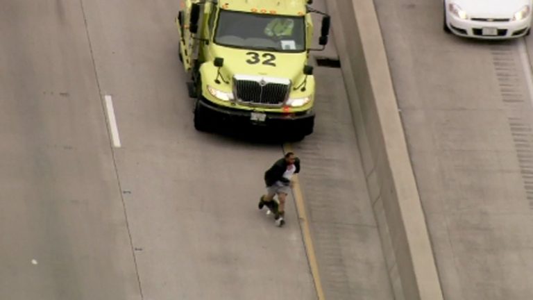 Video: man running from cops on freeway probably regrets not wearing a belt