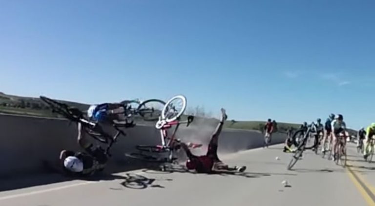 Crash launches bike over bridge, cyclist barely holds on