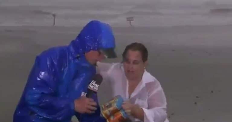 [WATCH] Woman gifts reporter covering Hurricane Harvey a six-pack of beer