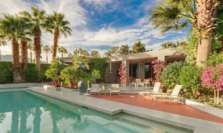 Rancho Mirage place with golf course views and a hanging fireplace listed at just under $3 million