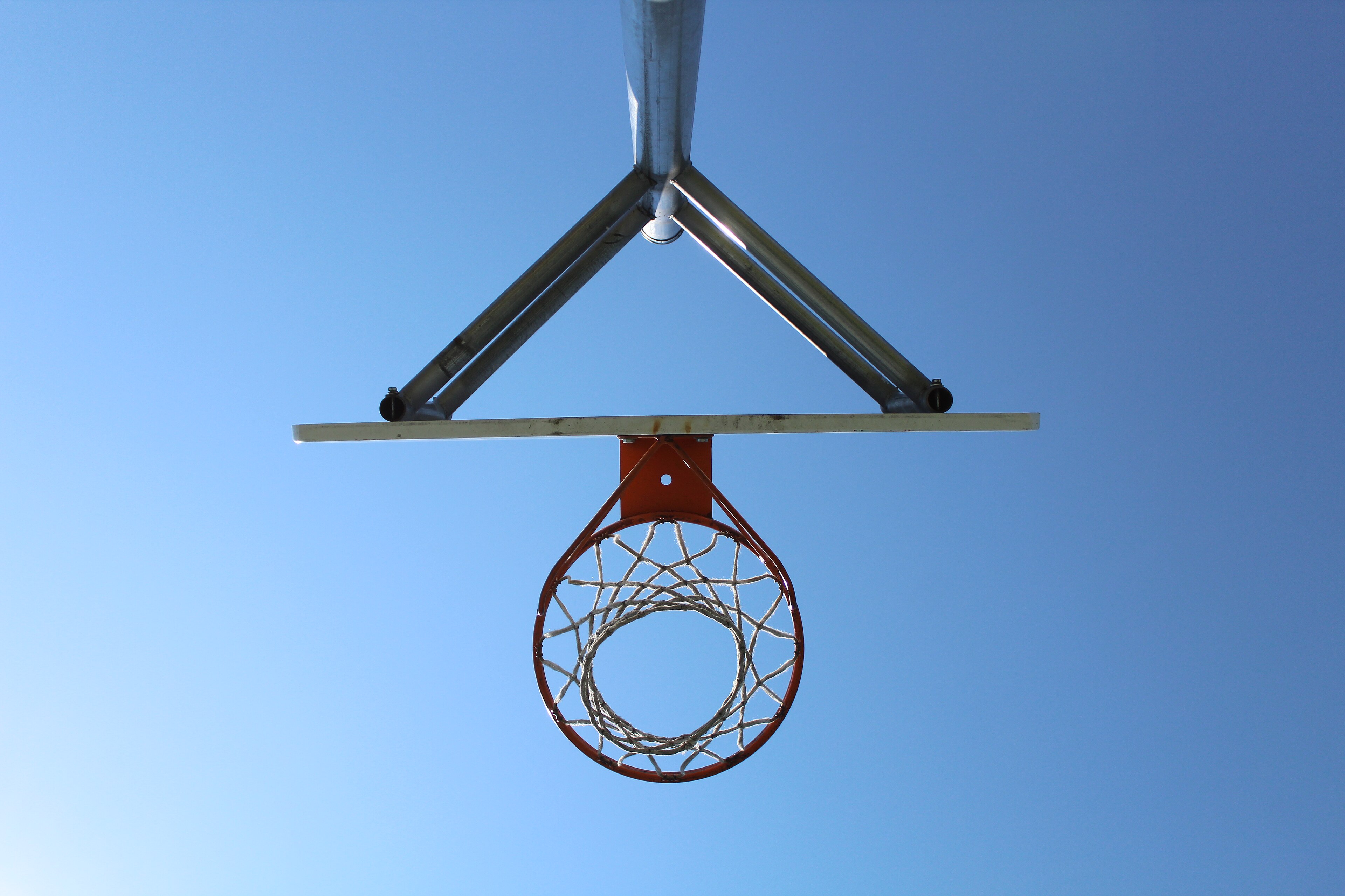A basketball hoop and net seen from below