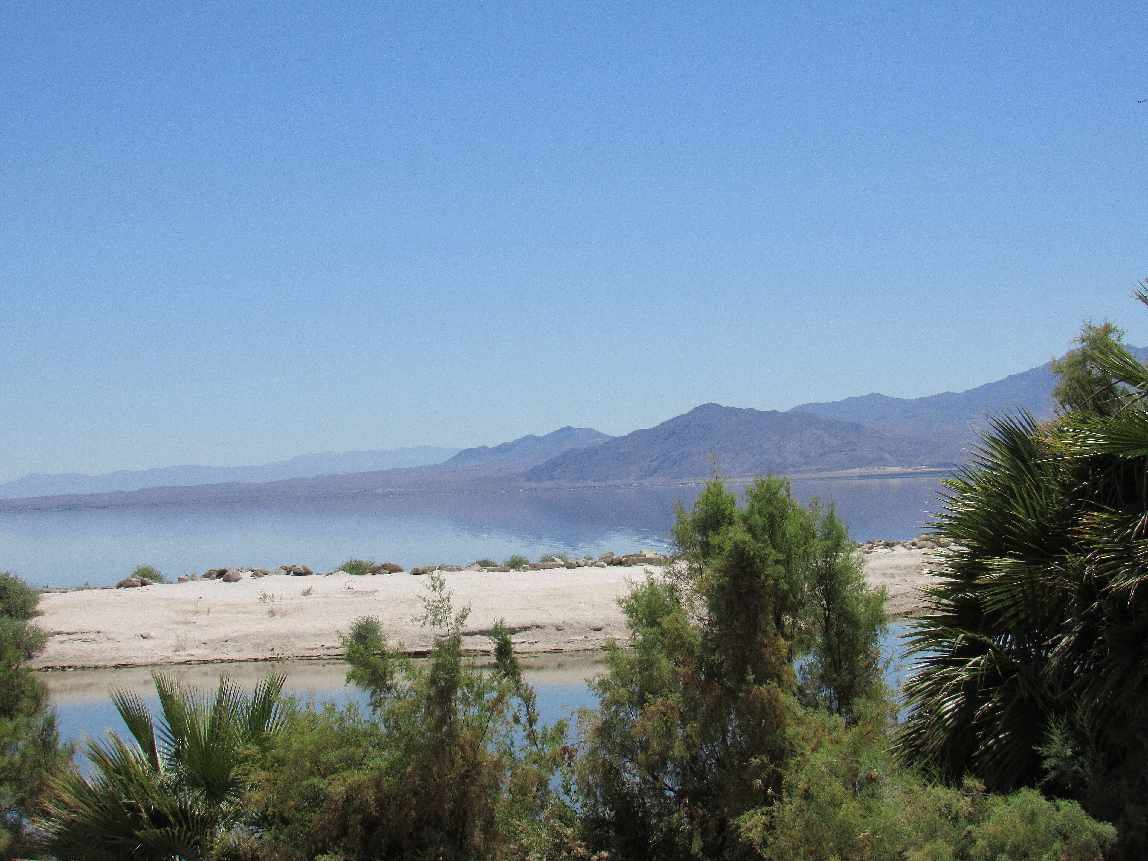 The Salton Sea shoreline at North Shore with mountains across the water